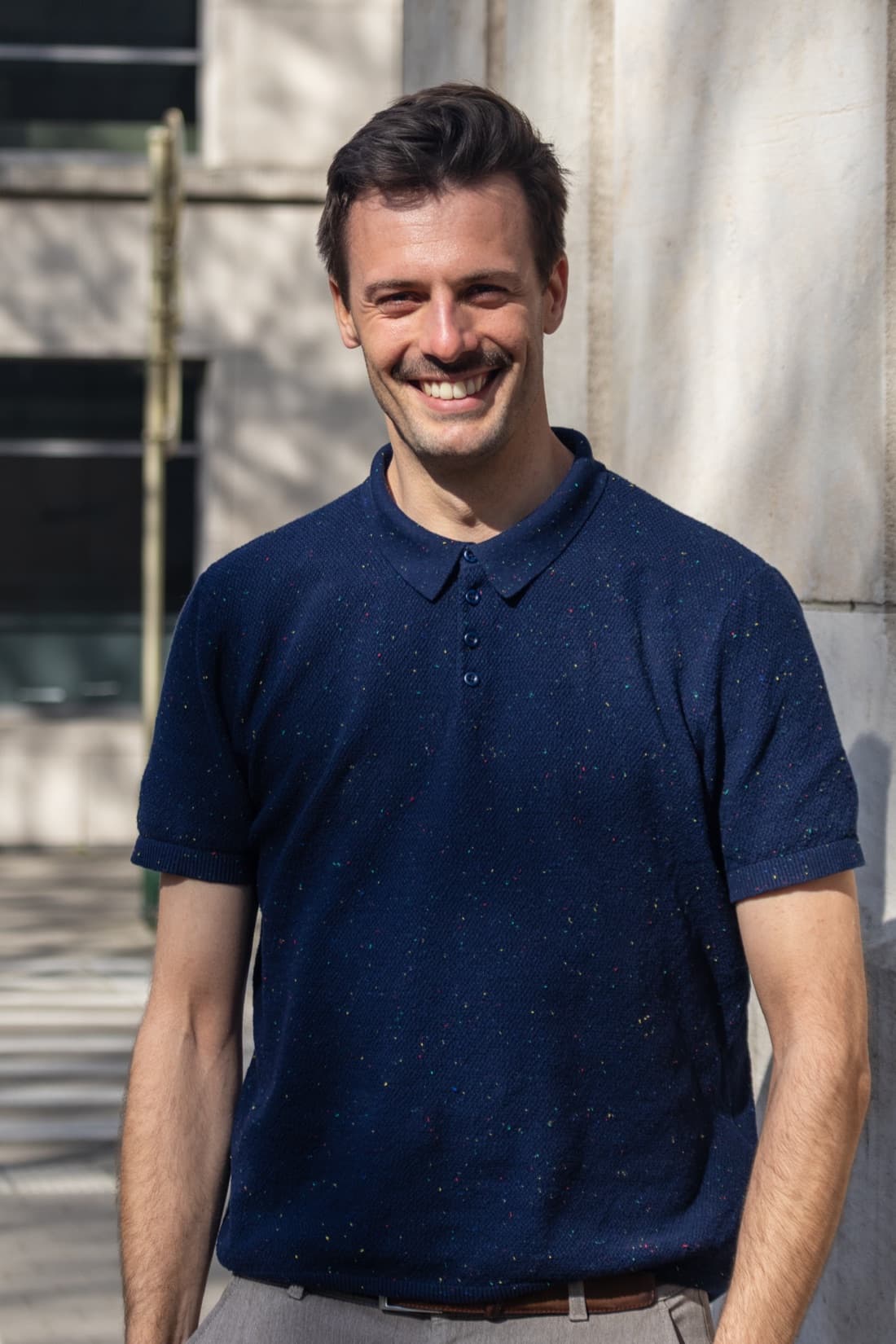 Jeroen Thierens, smiling in a navy polo in front of a stone facade